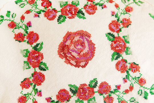 Decorative element, cross-stitch embroidery of rose flowers.