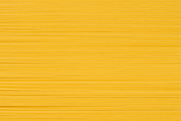 Raw thin spaghetti in rows, italian pasta. Food background concept