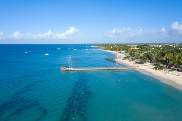 Fototapeta premium Dominicus beach at Bayahibe with Caribbean sea sandy seashore, lighthouse and pier. Aerial view