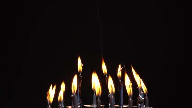 Black candles selective focus. Witchcraft altar for satanic rituals. Dark background for performing mystical esoteric ritual. Macabre and witch spells darkness for Halloween concept.
