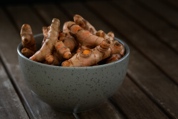 Turmeric roots in bowl