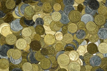 Yellow white texture of a pile of ukrainian small coins