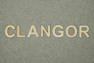 text on word clangor from wooden letters on a gray background