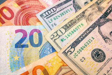 Fototapeta na wymiar US Dollars and Euros banknotes in close-up photography with top view. Global business concept, foreign exchange market and investments 