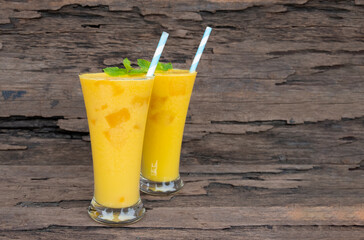 Mango  fruit smoothies yogurt drink yellow healthy delicious taste in a glass slush for weight loss on wooden background.