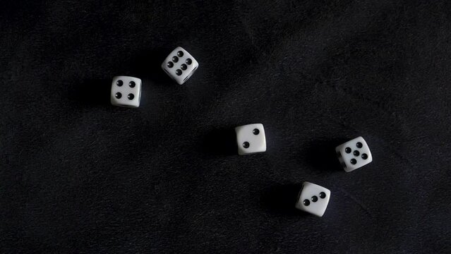 Five dice roll in slow motion, land on 2 3 4 5 6 sequence. Black background.