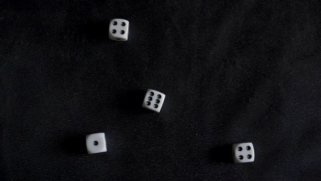 Four dice rolled, land on pair of 4s, 1 and 6. Fifth die rolls out of frame. Slow motion.
