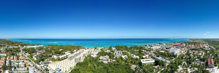 Caribbean beach of Atlantic ocean with luxury resorts, palm trees and turquoise water. travel destination. Aerial panorama view - obrazy, fototapety, plakaty