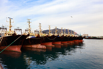 Several deep-sea fishing boats anchored at the port.
