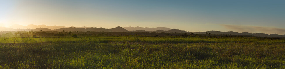 Fototapeta premium Colored gradient hills at sunlight and fug, sunset