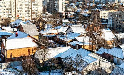 Fototapeta na wymiar City street with houses covered with snow