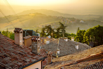 Sunset view of San Marino microstate and Emilia-Romagna region of Italy from the rooftops of the...