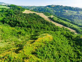 Aerial views of green fields and hills surronding San-Marino microstate. Travelling across the beautiful Emilia-Romagna region of Italy.