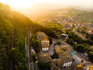 Sunset aerial view of San Marino microstate and Emilia-Romagna region of Italy from the rooftops of...
