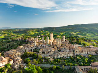 Aerial view of famous medieval San Gimignano hill town with its skyline of medieval towers, including the stone Torre Grossa. UNESCO World Heritage Site. - obrazy, fototapety, plakaty