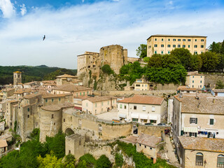 Obraz premium Aerial view of Sorano, an ancient medieval hill town hanging from a tuff stone over the Lente River.