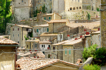 Rooftops of Sorano, an ancient medieval hill town hanging from a tuff stone over the Lente River. - obrazy, fototapety, plakaty