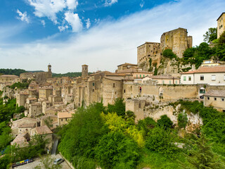 Fototapeta na wymiar Aerial view of Sorano, an ancient medieval hill town hanging from a tuff stone over the Lente River.