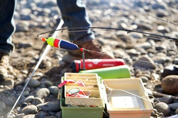 fishing tackle with mans foot in background