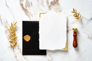 Flat lay luxury wedding invitation card mockup, black envelope, gold wax seal stamp, golden leaves....