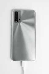 Grey cell phone connected to USB cable type C - Charging