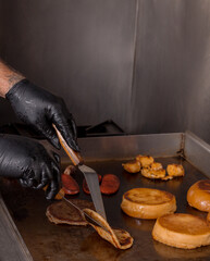 person preparing a burger
