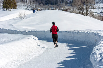 Jogging along Yampa River trail in winter;  Steamboat Springs, Colorado