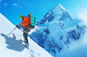 Mountaineer reaches the top of a snowy mountain peak Everest. Extreme sport concept. Nepal mountains. - 484544999