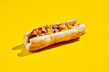 Chiken cheesesteak in minimal style. American fast food in yellow background with shadow. Philly...