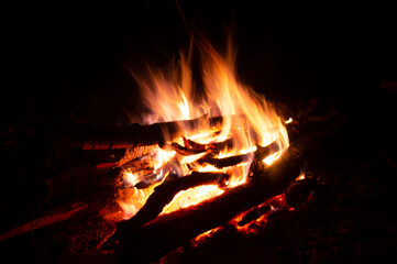 Defocused fire background, blurred white and  orange fire flames in the night texture, red shining coals