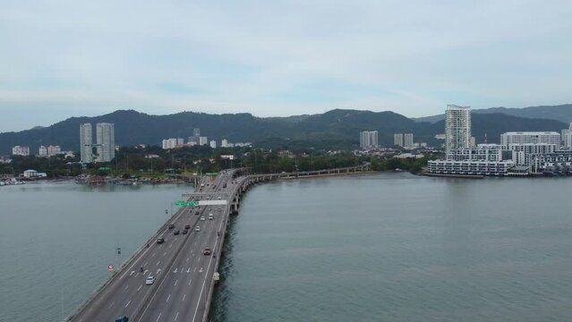 Aerial drone shot of the first Penang Bridge, view facing the island. The bridge connects Prai on the mainland of Malaysia, crossing the Penang Strait.