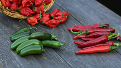 Fresh Peppers outdoors at rural farmers market, Jalapeno, Cayenne and Bhut Jolokia