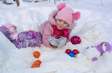 Fototapeta na wymiar Portrait of a girl in a New Year's snowy winter forest.