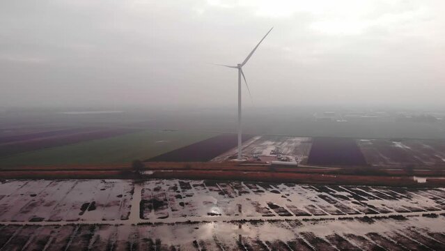 Aerial View Of New Wind Turbine Seen Through Morning Fog In Fields In Barendrecht. Dolly Forward