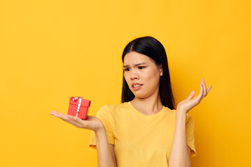 woman with Asian appearance holding a gift box in his hands posing isolated background unaltered