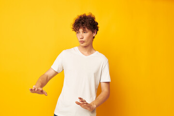 red-haired guy in a white t-shirt on a yellow background