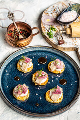 Potato pancakes with sour cream, herring fillets and purple onions, Crispy potato pancakes, Delicious breakfast or snack, Clean eating, dieting, vegan food concept. top view