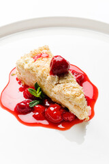 napoleon cake with cherry sauce and mint