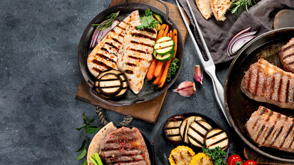 Grilled barbecue meat assortment on dark background.