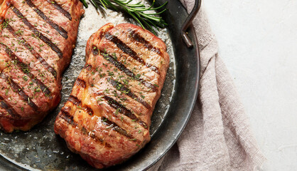 Grilled steak on light background. Homemade food concept.