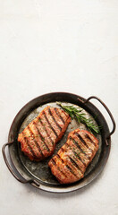 Grilled steak on light background. Homemade food concept.