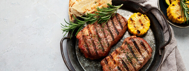 Grilled steak on light background. Homemade food concept.