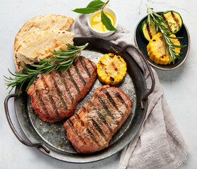 Grilled steak on light background. Homemade food concept.