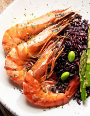 Shrimps with brown rice on light gray background.