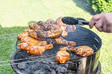 Cooking barbecue chicken wings coal on grill glowing coals bbq in the garden