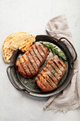 Grilled steak on light background. Homemade food concept.