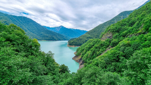 Jvari reservoir on river Enguri (Inguri). Beautiful mountain landscape. Lake with turquoise colored water surrounded by the Central Caucasus mountain ranges, Svaneti Region in Georgia. Road to Mestia.