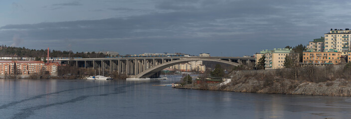 A cliff ness with functionalist styled houses in the district Kungsholmen and the bridge to the district Bromma, a cold sunny winter day in Stockholm