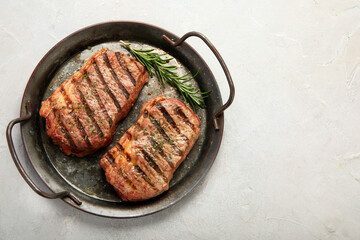Grilled steak on light background. Homemade food concept.