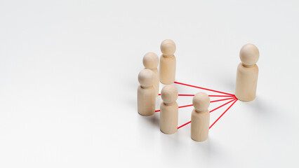 Wooden peg dolls are connected together with red lines on white background. Teamwork, Leadership,...